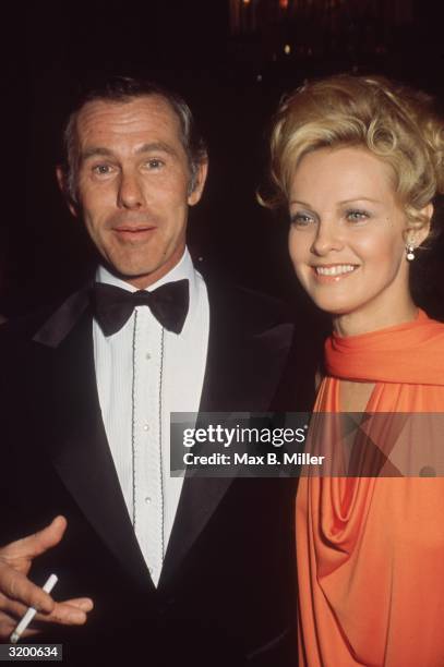 American comedian and television personality Johnny Carson and American actor Angel Tompkins attend the Golden Globe Awards, where Tompkins was...