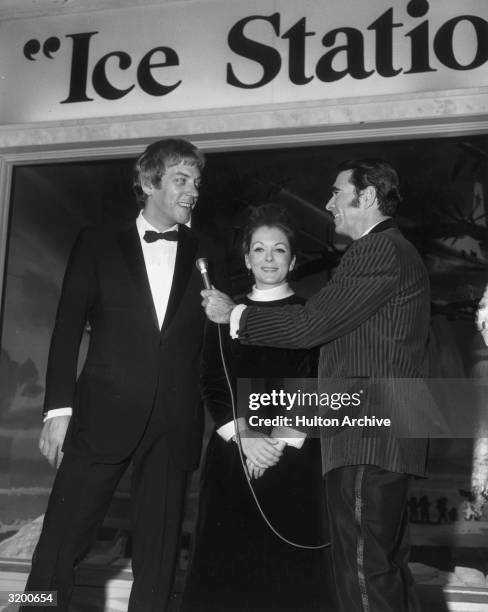 Low-angle view of Canadian actor Donald Sutherland , wearing a tuxedo, standing next to his first wife, actor Shirley Douglas, as he talks to...