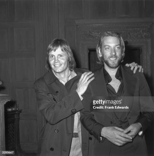 American actor Jon Voight places his hands on the shoulders of Canadian actor Donald Sutherland at the American Film Institute reception for Italian...