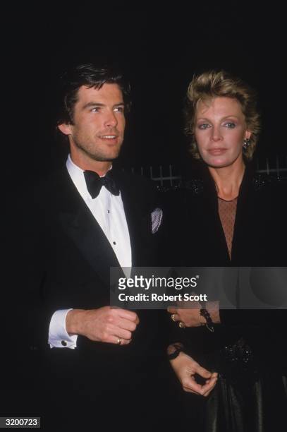 Actor Pierce Brosnan and his wife Cassandra Harris in formal attire attend the 11th Annual People's Choice Awards on March 14, 1985.