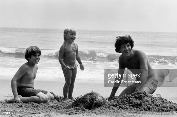 American actor Dustin Hoffman enjoying a day at the beach with his children.