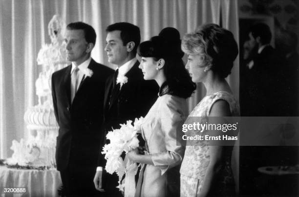 Tony Curtis marrying Christine Kaufmann after they co-starred in the Universal comedy 'Wild And Wonderful'. Fellow actor Kirk Douglas attends the...