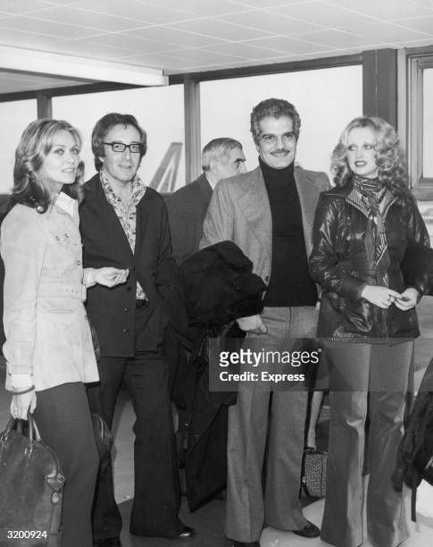British actor Peter Sellers and Egyptian actor Omar Sharif at Heathrow Airport, with Alexandra Bastedo and Kathy Downes, London, England. All were...