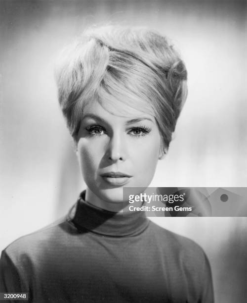 American actor Barbara Eden has a bouffant hairdo and wears a mock turtleneck sweater in a promotional studio portrait for TV's, 'I Dream of Jeannie.'