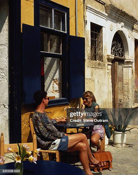 young couple sitting outside restaurant,chania,crete,greece - präfektur chania stock-fotos und bilder