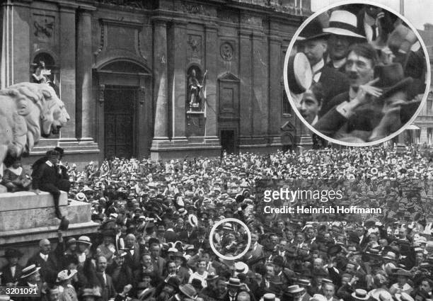 High-angle view of a crowd gathered in the Odeon Platz in Munich, Germany. An inset shows future Nazi leader Adolf Hitler in the crowd.