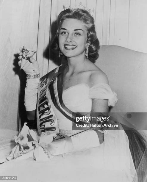 Portrait of Marian Ann McKnight, Miss America 1957, holding a paper cup of Minute Maid orange juice after her coronation ceremonies, Atlantic City,...