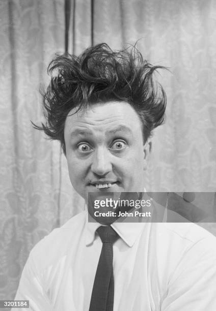 English comedian Ken Dodd, with his trademark wild hair and buck teeth.