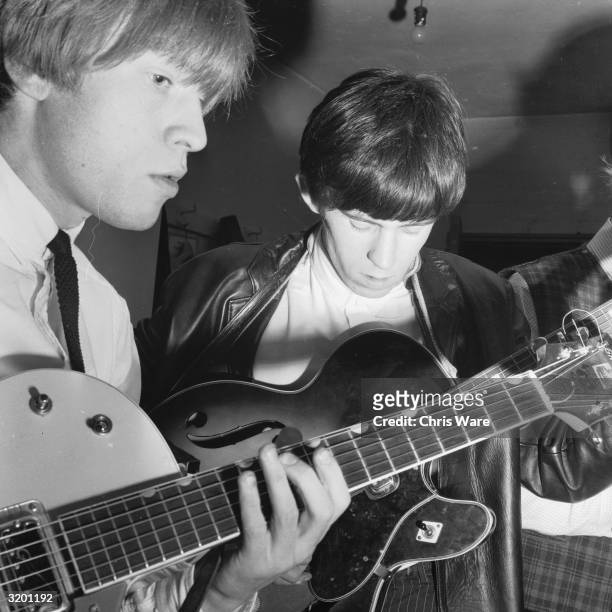 The two guitarists from the Rolling Stones, Keith Richards and Brian Jones playing guitar.