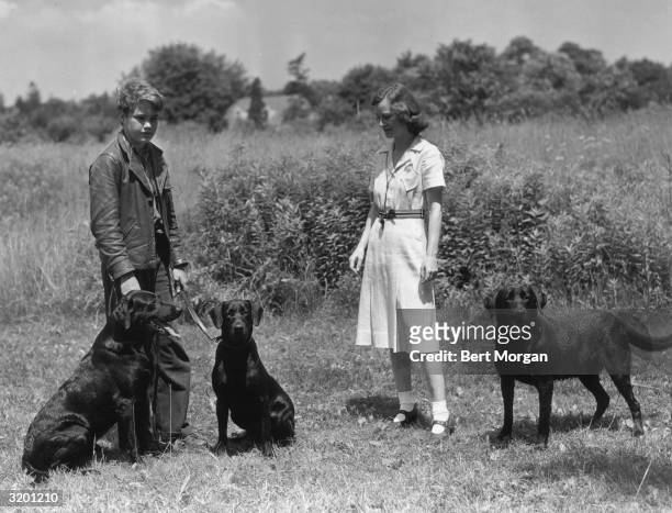 Peter Potter and Kathleen B. Starr of Islip, Long Island, stand in a farm field with three Labrador retrievers. Potter was the son of dancer Fred...