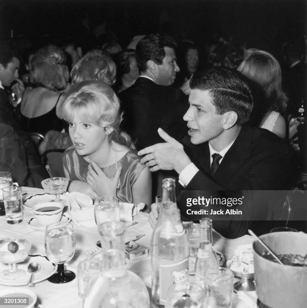 British-born actor Hayley Mills and Frank Sinatra Jr. Gesture with their hands while talking to an unseen person at a Sammy Davis Jr. Performance,...