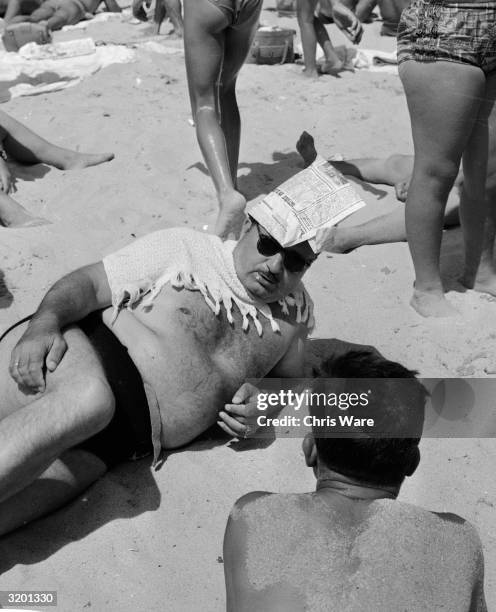Man wearing an improvised sunhat at Varna, the Bulgarian holiday resort on the Black Sea.
