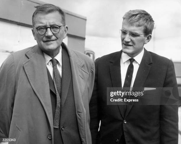 Russian classical composer Dmitri Shostakovich and his son Maxim arrive at London Airport, on their way to the Edinburgh music festival, England....