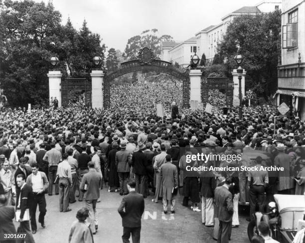 Masses of people crowd through Sather Gate to hear American political activist Norman Thomas's anti-war address, on the campus of the University of...