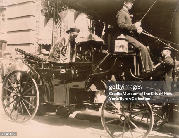 Chinese statesman and general Li Hung Chang sits in a horsedrawn carriage, outside the Waldorf-Astoria hotel, West Thirty-Third Street, off Fifth...