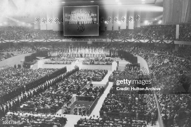 High-angle view of a mass meeting of the Nazi party, held to raise funds to feed the poor during the winter months, at the Deutschlandhalle, Berlin,...