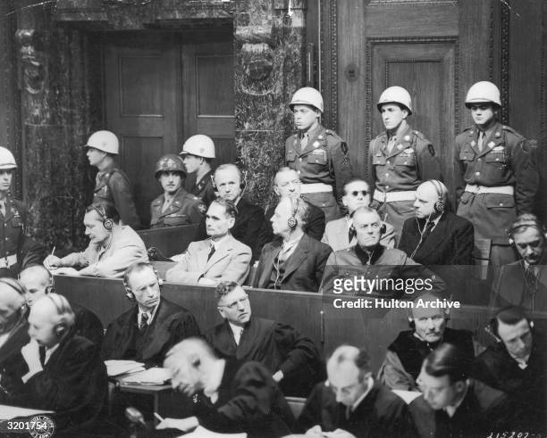 Members of Adolf Hitler's Third Reich sit in the witness box with headsets on, on the third day of the International Military Tribunal's war crimes...