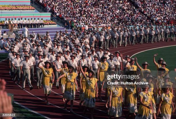 Athletes in costume march in the opening ceremony parade at the Summer Olympics, Olympic Stadium, Los Angeles, California.