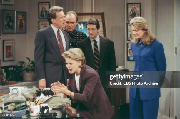 American actors Charles Kimbrough, Joe Regalbuto, Grant Shaud and Candice Bergen watch Faith Ford as she reacts to a cat sitting beside an empty...