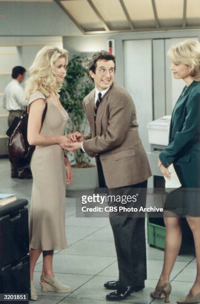 Actor Grant Shaud holds model-turned-actor Vendela Kirsebom's hand while looking over his shoulder and smiling at Faith Ford in a full-length still...