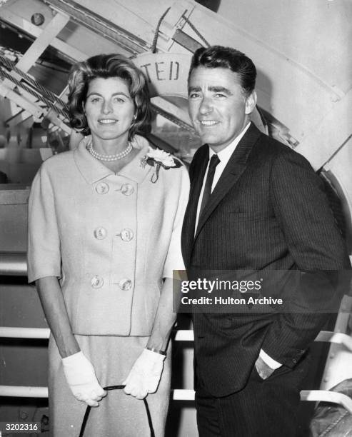 Patricia Kennedy and her husband, British actor Peter Lawford , pose together on the gangplank of a ship. Patricia wears a double-breasted blazer and...