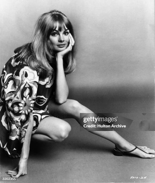 British model Jean 'The Shrimp' Shrimpton rests her face in her palm while crouching, in a promotional portrait for director Peter Watkins's film,...