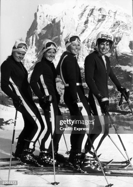 British skiers Valentina Iliffe, Carol Blackwood, Gina Hathorne and Divina Galica of the women's Olympic team pose in a row on a ski slope in...