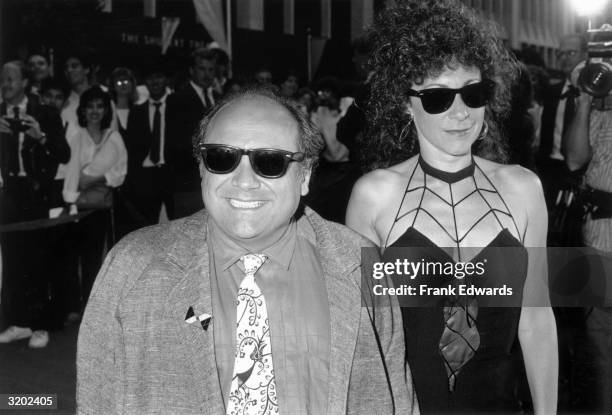 American actor and director Danny DeVito smiles with his wife, actor Rhea Perlman, while attending the premiere of Jim Abrahams and David Zucker's...