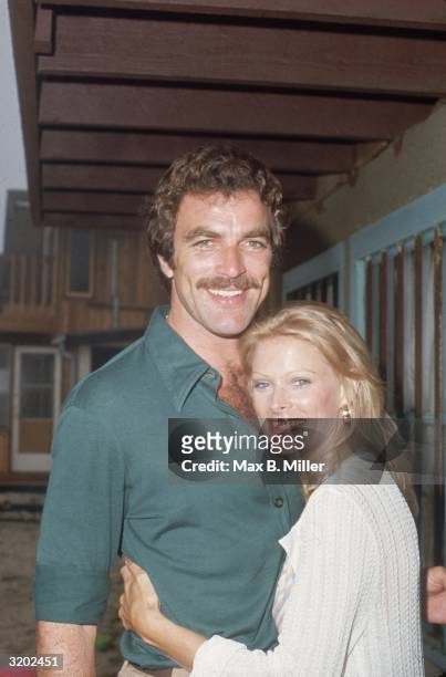 American actor Tom Selleck and his wife, Jacquelyn Ray, hugging at actor Robert Colbert's birthday party, at Colbert's home in Malibu, California....