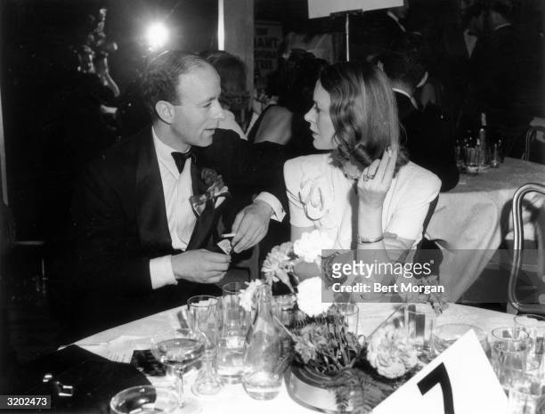 Herbert A. Scheftel and Lady Sylvia Ashley talk while sitting at a table during the Star Spangled Ball, Astor Hotel, New York City. Ashley was the...