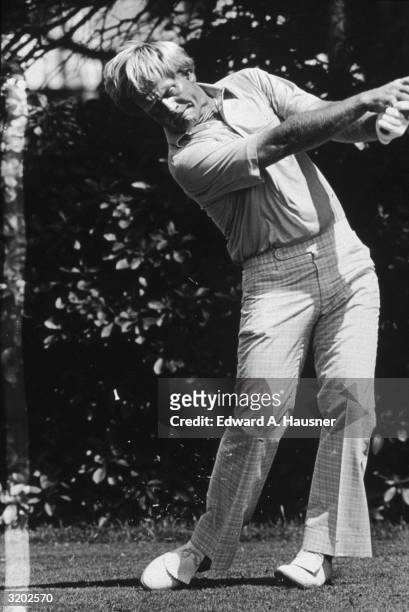 Full-length image of American professional golfer Jack Nicklaus swinging a golf club after driving off the second tee during the U.S. Open, Baltusrol...