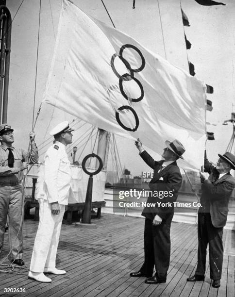 Full-length view of Quartermaster Richardson L. Bangs, Captain John W. Anderson, Avery Brundage, President of the United States Olympic Committee ,...