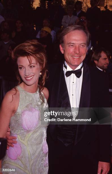 British-born actor Jane Seymour and her fourth husband, American actor James Keach, smile while attending the American Film Institute's salute to...