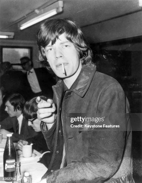 Mick Jagger, the lead singer of the Rolling Stones, smoking a cigarette.