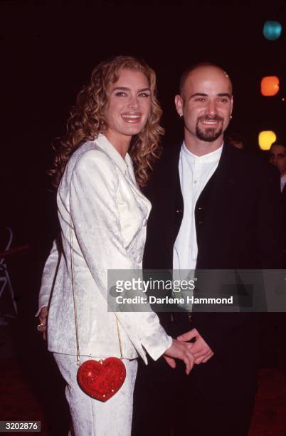 Actor Brooke Shields and tennis player Andre Agassi smile while holding hands at the 11th Annual American Comedy Awards, Los Angeles, California....
