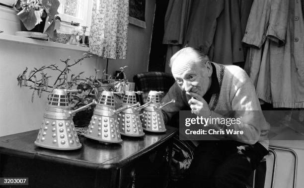 British actor, William Hartnell at home in Mayfield, Sussex with four miniature model Daleks - arch enemies of Hartnell's character Dr Who in the...