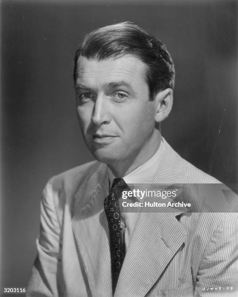 Headshot studio portrait of American actor James Stewart wearing a seersucker suit.