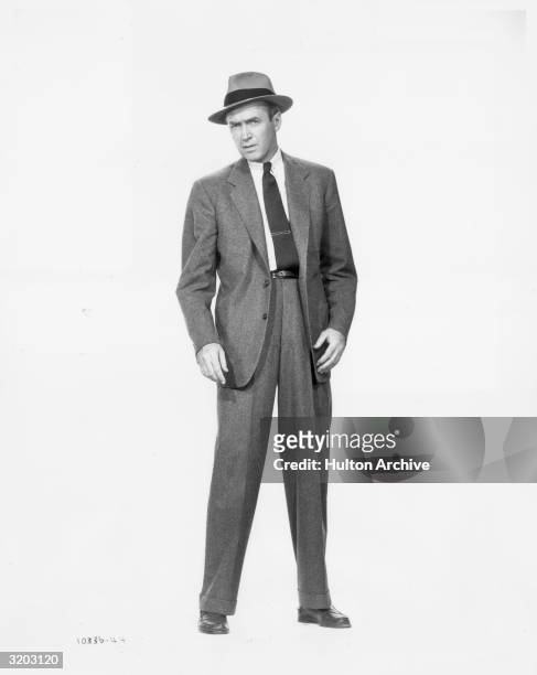 Full length promotional portrait of American actor James Stewart in a suit and a hat, from director Alfred Hitchcock's film, 'Vertigo.'