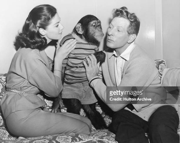 American actor Danny Kaye and Italian-born actor Pier Angeli on the set of director Michael Kidd's film, 'Merry Andrew,' with their co-star, Chim the...