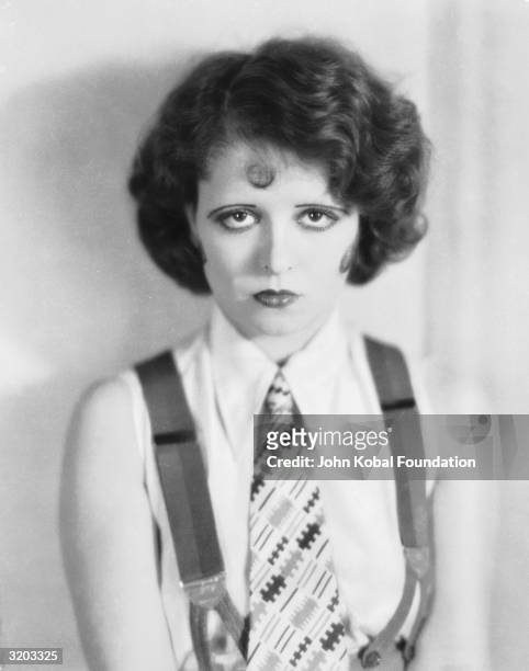 Hollywood sex-symbol, Clara Bow dressed in unusually masculine style in sleeveless shirt, tie and braces.