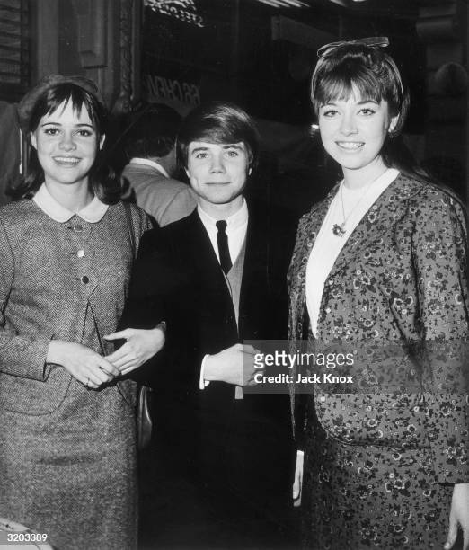 American actors Sally Field, Jon Provost and Angela Cartwright smile while attending an event. All were appearing in TV series: Field played...