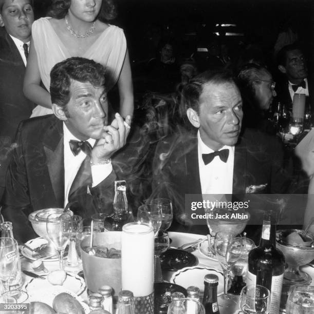 American singers and actors Dean Martin and Frank Sinatra attend the opening night performance of American singer Eddie Fisher at the Cocoanut Grove,...