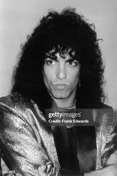 Headshot of American singer Paul Stanley, a.k.a. Star Lover, of the rock group Kiss, with his lips pursed and his arms folded in front of his chest...