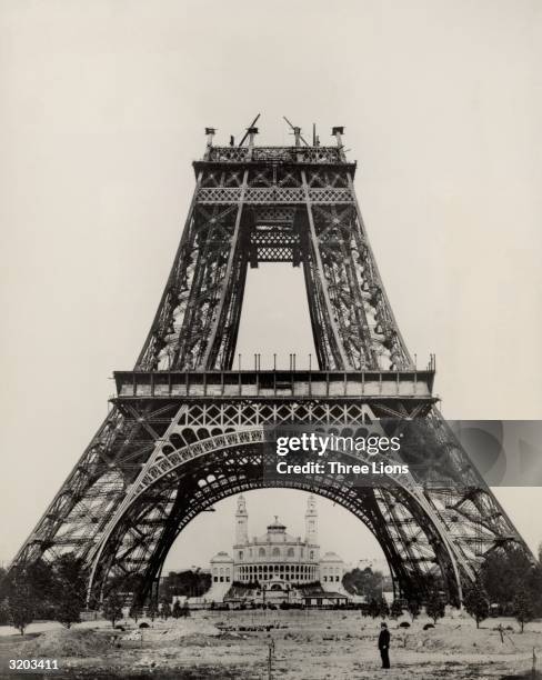 French civil engineer Gustave Eiffel stands at the base of the Eiffel Tower during its construction, Paris, France, August 21, 1888. The tower, which...