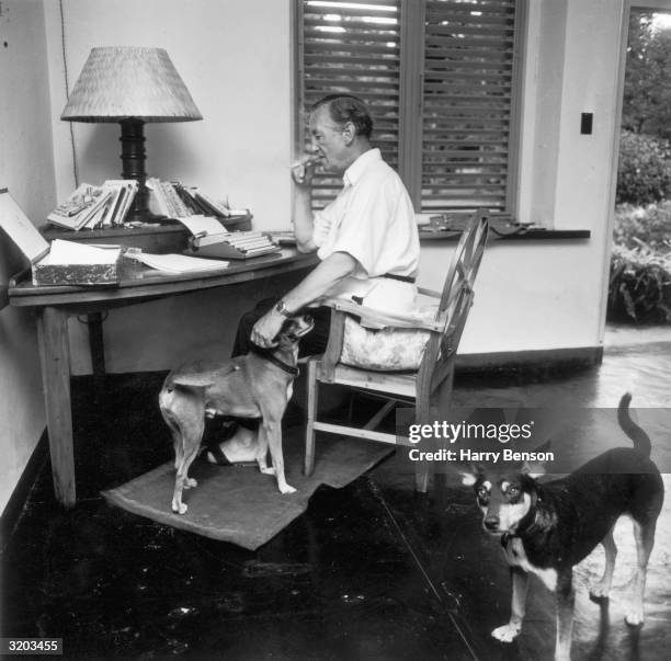 English writer Ian Fleming , best known for his James Bond novels, in his study at Goldeneye, his Jamaican home.