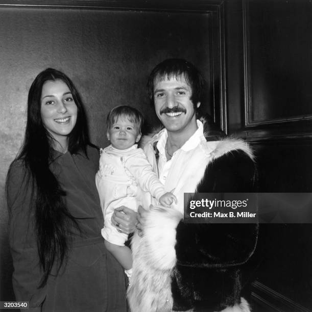 Married American singing duo Sonny and Cher smiling and holding their infant daughter Chastity at Zsa Zsa Gabor's opening at 'The Flamingo,' Las...