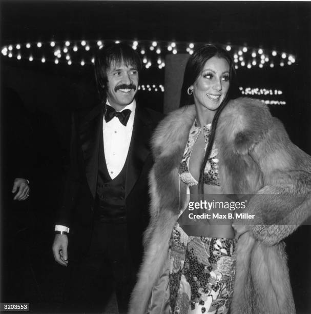 American singers Sonny and Cher attend the Golden Globe Awards, Los Angeles, California. Sonny Bono wears a tuxedo; Cher wears a midriff-baring two...