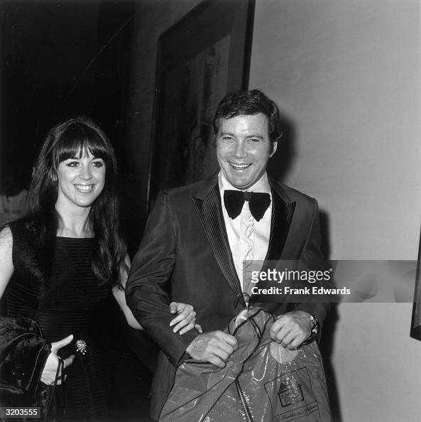 Canadian-born actor William Shatner laughs while carrying a garment ...