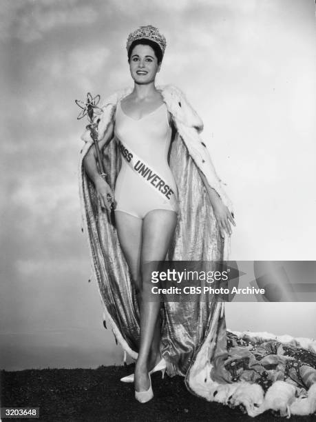 Full-length portrait of Norma Beatriz Nolan of Buenos Aires, Argentina, Miss Universe 1962, wearing a crown, a bathing suit, an ermine-trimmed cape,...