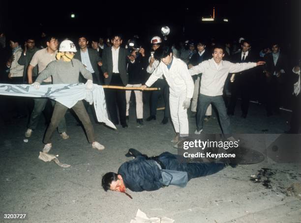 Student lies injured in the middle of a demonstration demanding the return of Okinawa and the abrogation of the US-Japan Security Treaty.